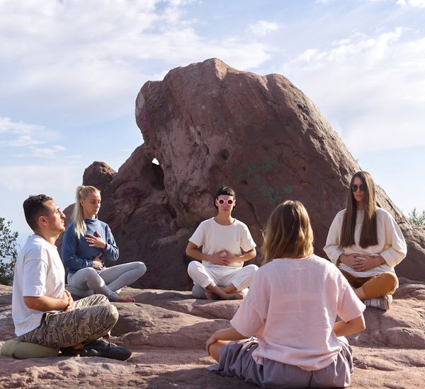 Group of people sitting in a circle during a yoga class.